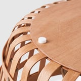 Handwoven wooden stool with curved legs and white plastic foot protector, ensuring stability and scratch-free surfaces.