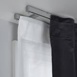 Ceiling-mounted VIDGA brackets support double curtains for light control and privacy, enhancing ceiling height.
