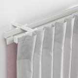 White curtain track system holding sheer curtains, allowing light control and privacy.