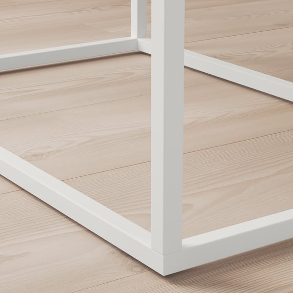 Theyre multiple wooden drawers on a white metal frame. The wood is light-colored and smoothly finished.