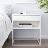 Minimalist VIKHAMMER bedside table with drawer, shelf, and items.