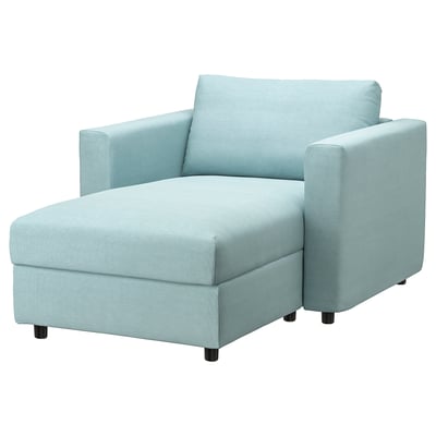Light blue chair with storage, curved back, armrests, dark feet.