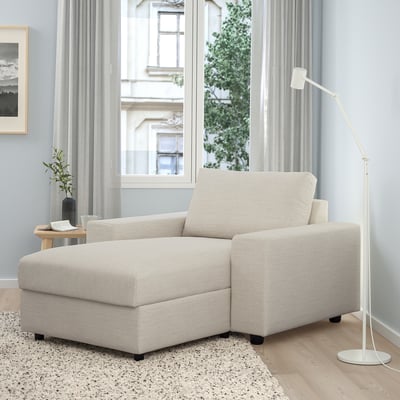 Modern living room with VIMLE beige sofa chaise, lamp, rug, and window view. Sofa is large, comfy, with storage.