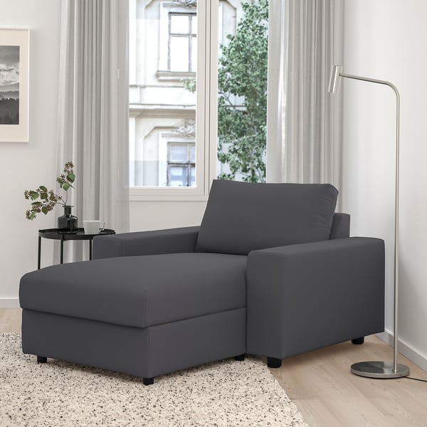 Modern gray l-shaped VIMLE sofa by window, fits well in bright room.