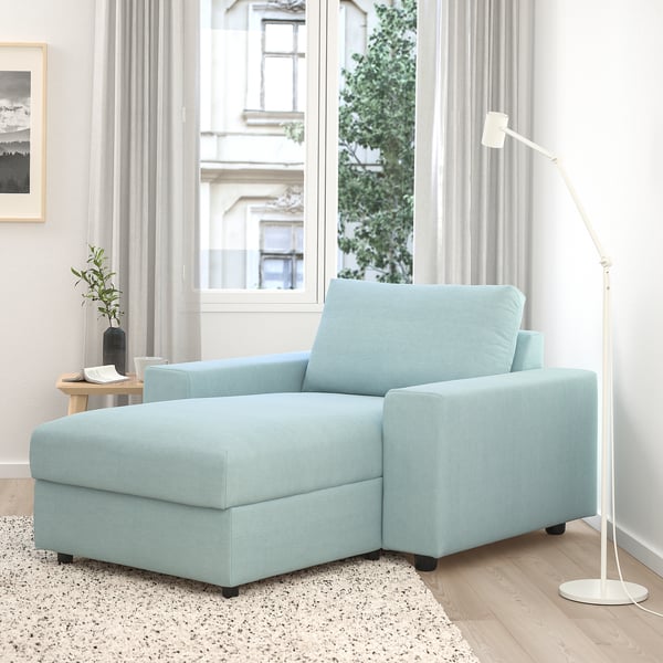 Light blue VIMLE chaise lounge sofa, spacious and modern, positioned near large window, with storage and adjustable headrest.