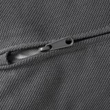 Close-up of a gray zipper on a textured fabric sofa, showcasing high-quality materials and durable design.