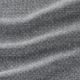 Close-up view of a soft, woven fabric with a subtle texture. Dark and light grey threads intertwine, creating a high-quality, detailed pattern.