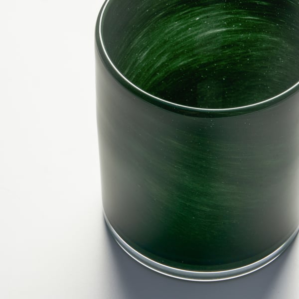 Dark green, handcrafted glass candle holder displayed prominently on a white background.