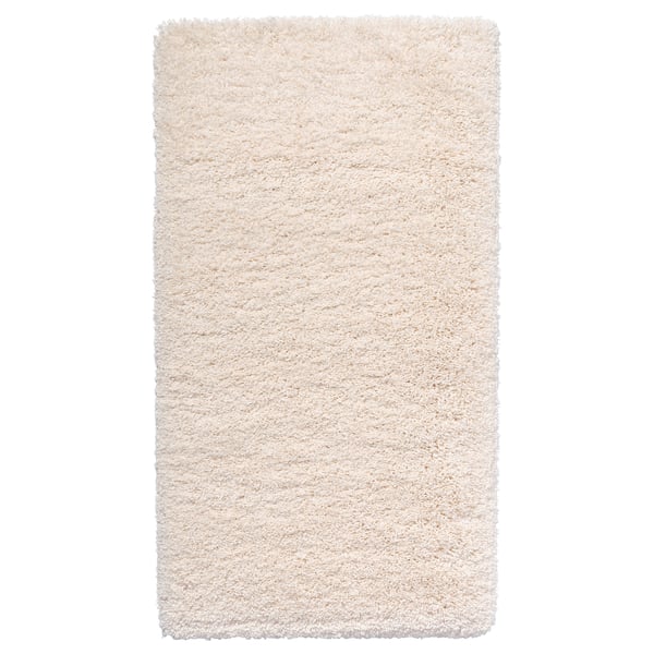 This is an a white, shaggy area rug with varying textures. Its rectangular and made from polypropylene.