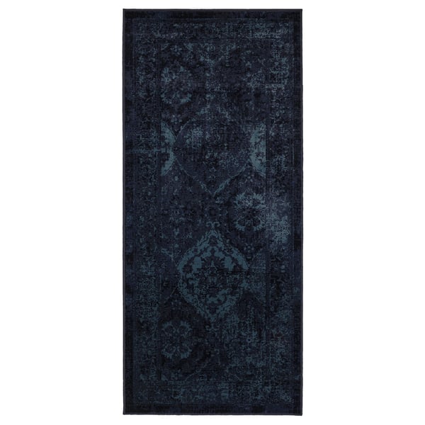 A dark blue VONSBÄK rug with a vintage, worn design. Its rectangular, made of polypropylene, and traditional patterns.