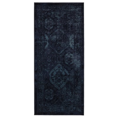 A dark blue VONSBÄK rug with a vintage, worn design. Its rectangular, made of polypropylene, and traditional patterns.
