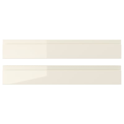 Two beige high-gloss VOXTORP drawer fronts with sleek, integrated handles.