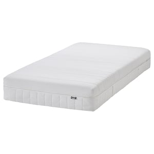 Een ÅNNELAND witte hybride matras, medium-stevig, met traagschuim, pluche lagen, pocketveren en comfortzones. Rechthoekige vorm met witte omslag.