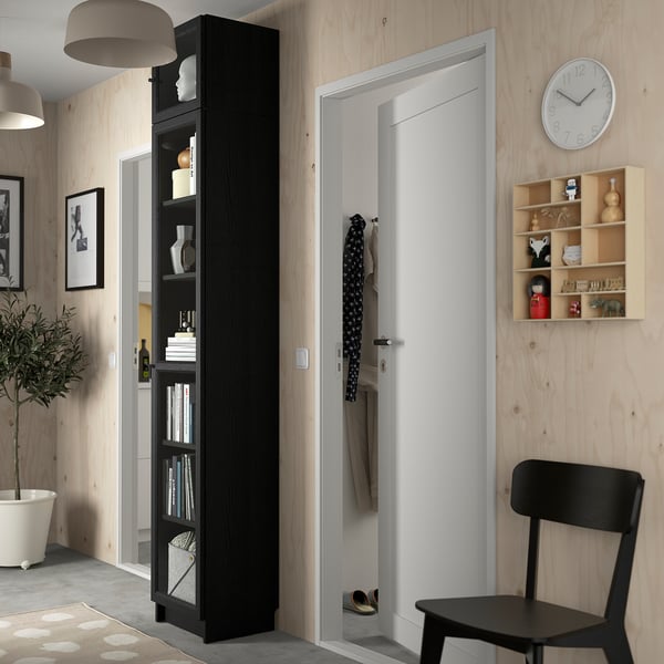 Moderne woonkamer met BILLY boekenkast, kast, stoel, plant.