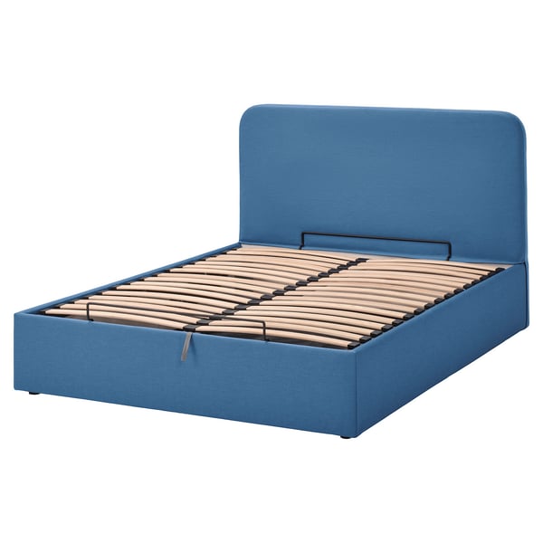 Blauw blåfjärlet bed met gestoffeerd hoofdeinde, houten latten en verborgen opbergruimte.