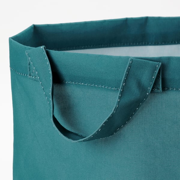 Close-up van stevige, turquoise handvatten van de opbergtas, met stiksels van topkwaliteit en duurzame stof.
