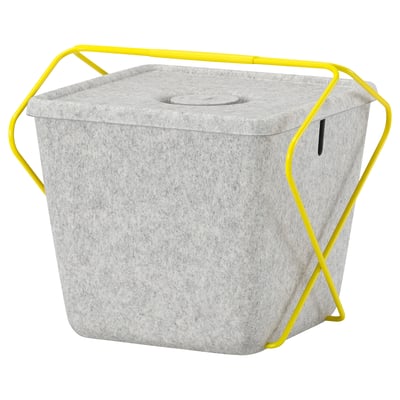 Grijze vilten BRÄNNBOLL mand met gele standaard, deksel en kabelgat voor gaming accessoires.