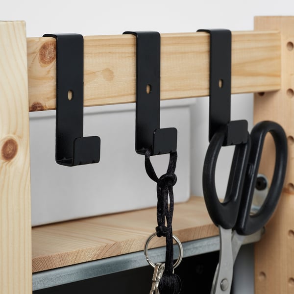 Houten plank met zwarte haken; Sleutels en schaar hangen.