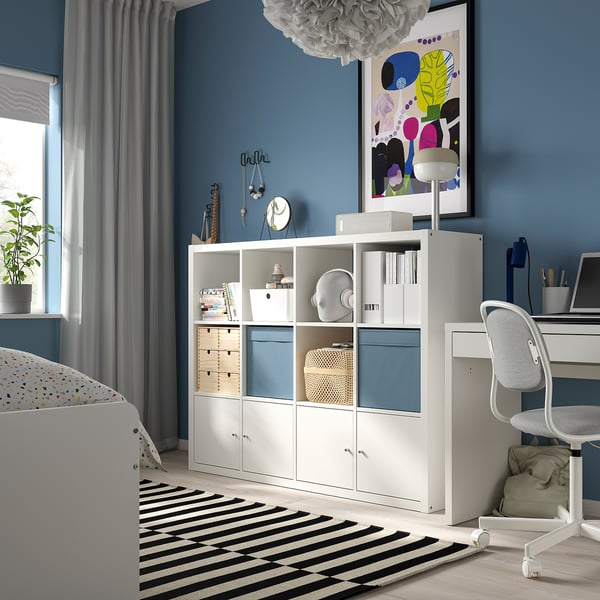 Moderne slaapkamer met KALLAX opbergmeubel, bureau en kleurrijke inrichting.