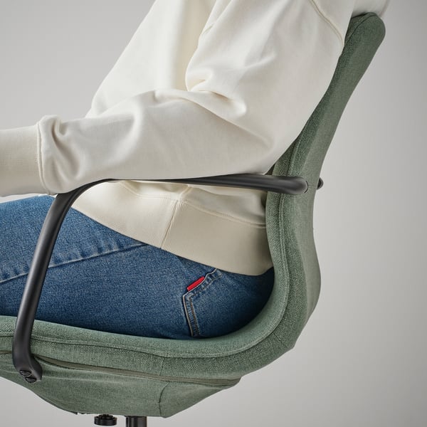 Persoon zittend op LÅNGFJÄLL bureaustoel, met in hoogte verstelbare zitting en lendensteun voor comfort.