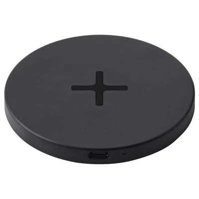 Een LIVBOJ zwart draadloos oplaadstation, rond van vorm met een strak design, met een usb-c-poort voor connectiviteit.