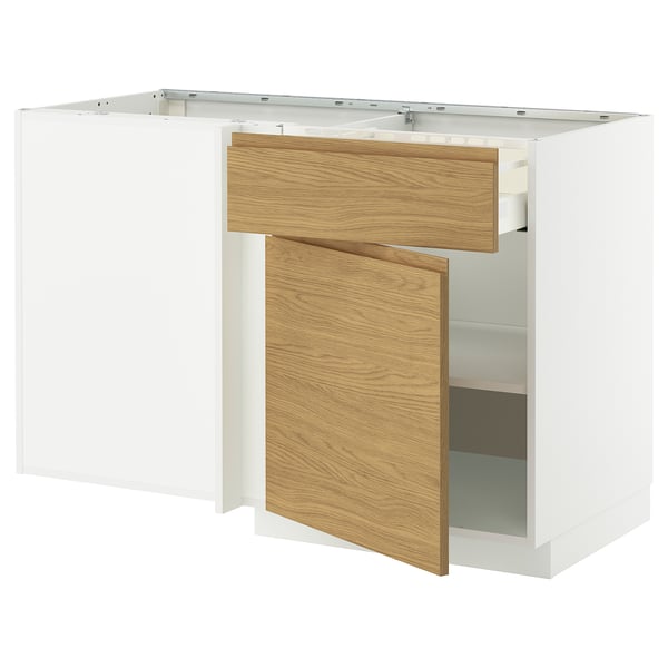 Deze afbeelding toont een witte METOD keukenkast met lades in eikeneffect. De kast heeft een modern, minimalistisch design met geïntegreerde handgrepen.