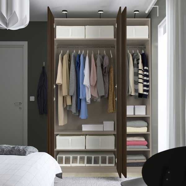 Moderne kast met kleding en planken, voorzien van langzaam sluitende deuren.