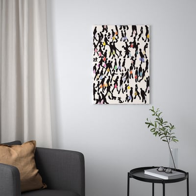 PJÄTTERYD canvas print met silhouetten boven grijze stoel.