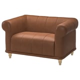 Bruin lederen VISKAFORS fauteuil, ronde vorm, diepe zitting, houten poten.