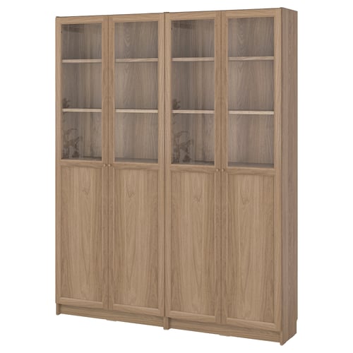 Large wooden bookshelf with glass doors. Ikea BILLY in light brown. Four sections, two with glass.