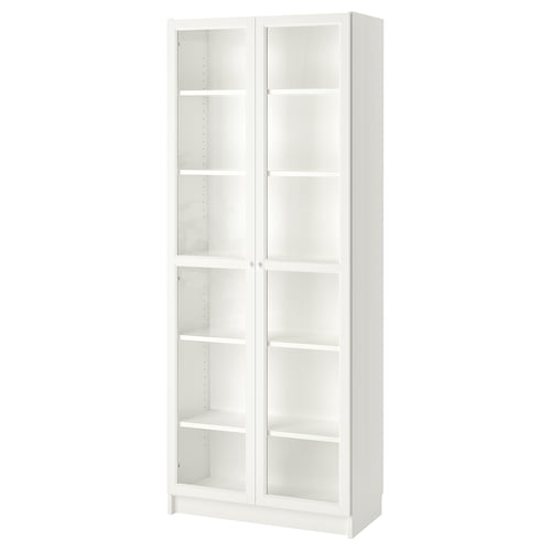 A white BILLY bookcase with glass doors, featuring adjustable shelves.