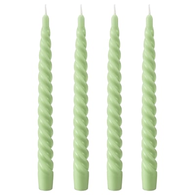 Four light green twisted candles, made of paraffin and plant-based wax, standing upright in a row.