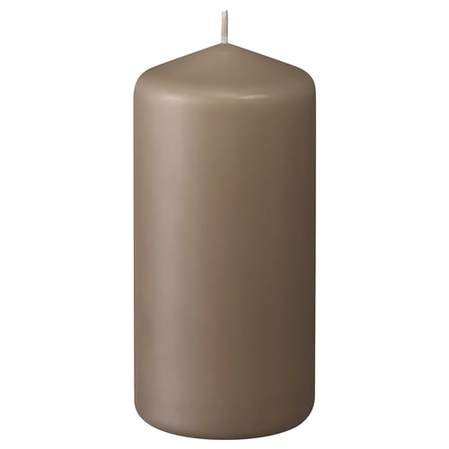 A brown DAGLIGEN pillar candle, made of paraffin and plant wax, with a cotton wick, standing upright with a smooth, cylindrical design.