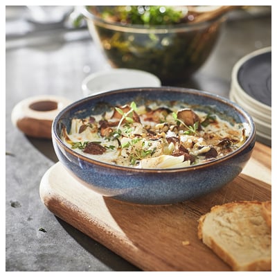Blue ceramic dish with bread. Delicious meal in a stylish bowl. Perfect for serving.
