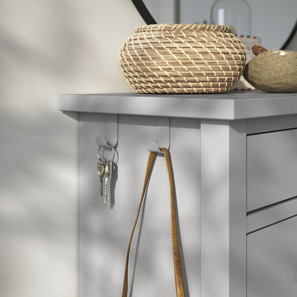 Grey GULLABERG shoe cabinet with woven basket, keys, and purse hooks.