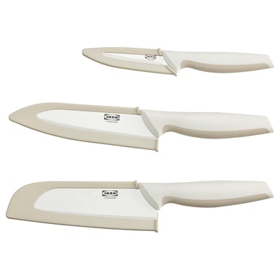 Three ceramic knives in off-white with plastic handles, displayed vertically. Ideal for slicing and chopping.