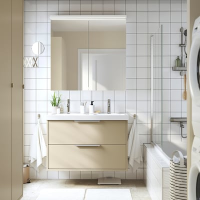 A sleek bathroom vanity in beige with a double ceramic basin. It modern drawers and is wall-mounted, offering ample storage and a clean look.