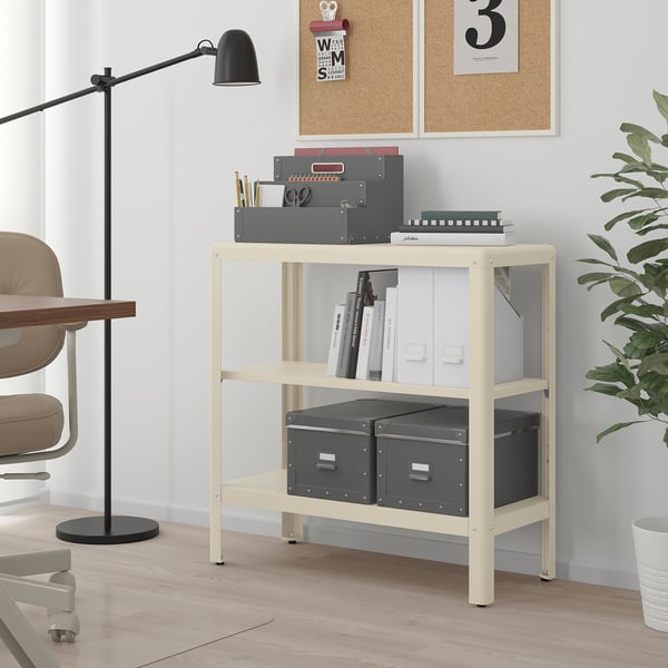 Ikea KOLBJÖRN white shelf with books, supplies, and plant.