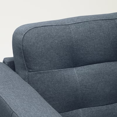 Close-up of a modern, grey upholstered sofa showing its neat stitching and plush fabric.