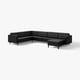 Black l-shaped leather sofa with tufted cushions and wooden legs.