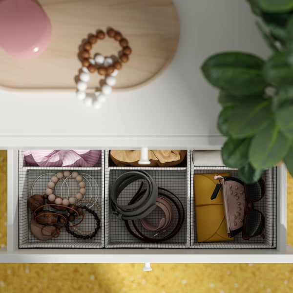 Organised jewellery drawer with grid organisers. Holds bracelets, belts, and accessories. Customizable, modern storage.