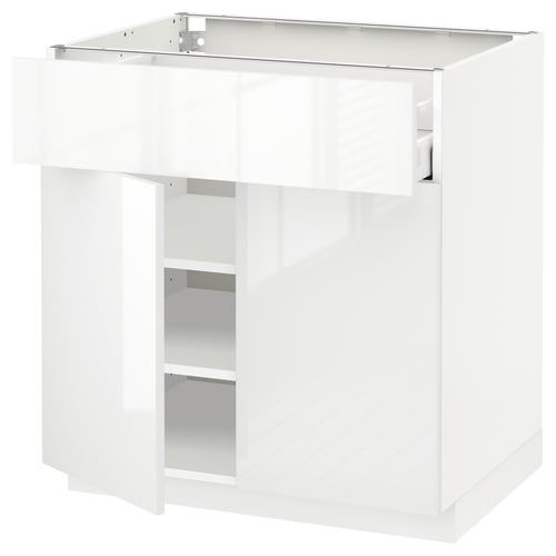 A white, high-gloss METOD kitchen cabinet with a modern design. It a smooth drawer and a sleek, reflective surface.