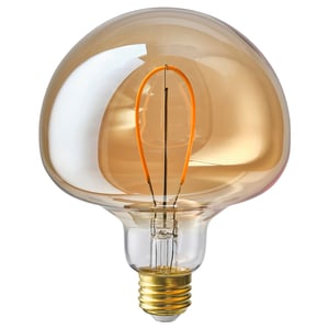 A brown MOLNART led bulb with a bell shape and golden filaments, made of glass.