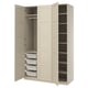 An open beige PAX wardrobe with shelves, hanging rod, and mesh baskets.