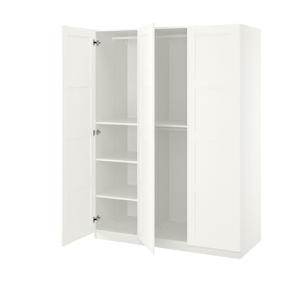 A white IKEA PAX wardrobe with open doors revealing empty shelves.