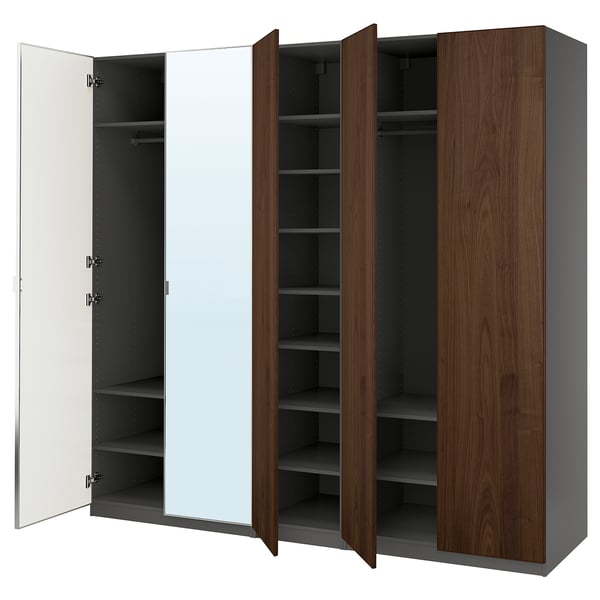 A PAX wardrobe with mirrored, wooden, and grey doors, featuring shelves inside.