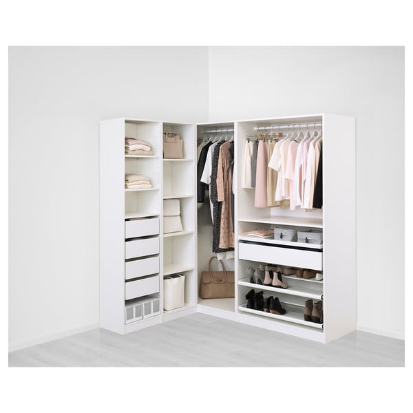 A modern, white PAX wardrobe corner unit showcasing organised clothes, shelves, and drawers, illustrating versatile storage solutions.