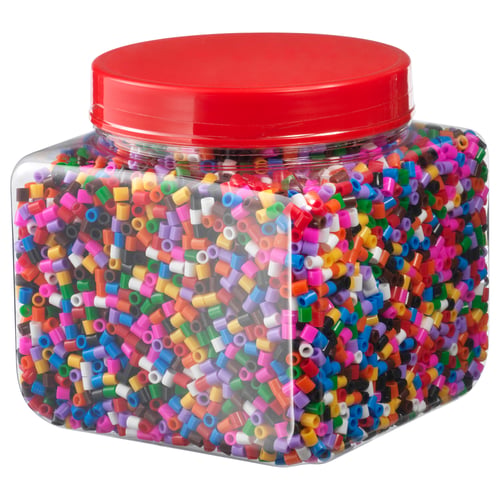 Red plastic bottle filled with multi-colored small beads for crafting.