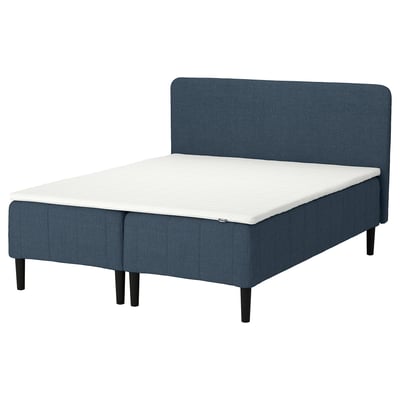 RÅHOLMAR: blue bed with upholstered headboard, wooden legs, white mattress.