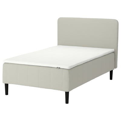 IKEA RÅHOLMAR: cream, upholstered bed with 5 comfort zones, dark wooden legs, sleek modern design.